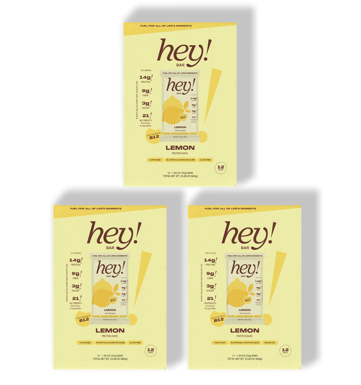 Three yellow packages of 'hey!' lemon bars: one larger box centered at the top and two smaller boxes side-by-side below.