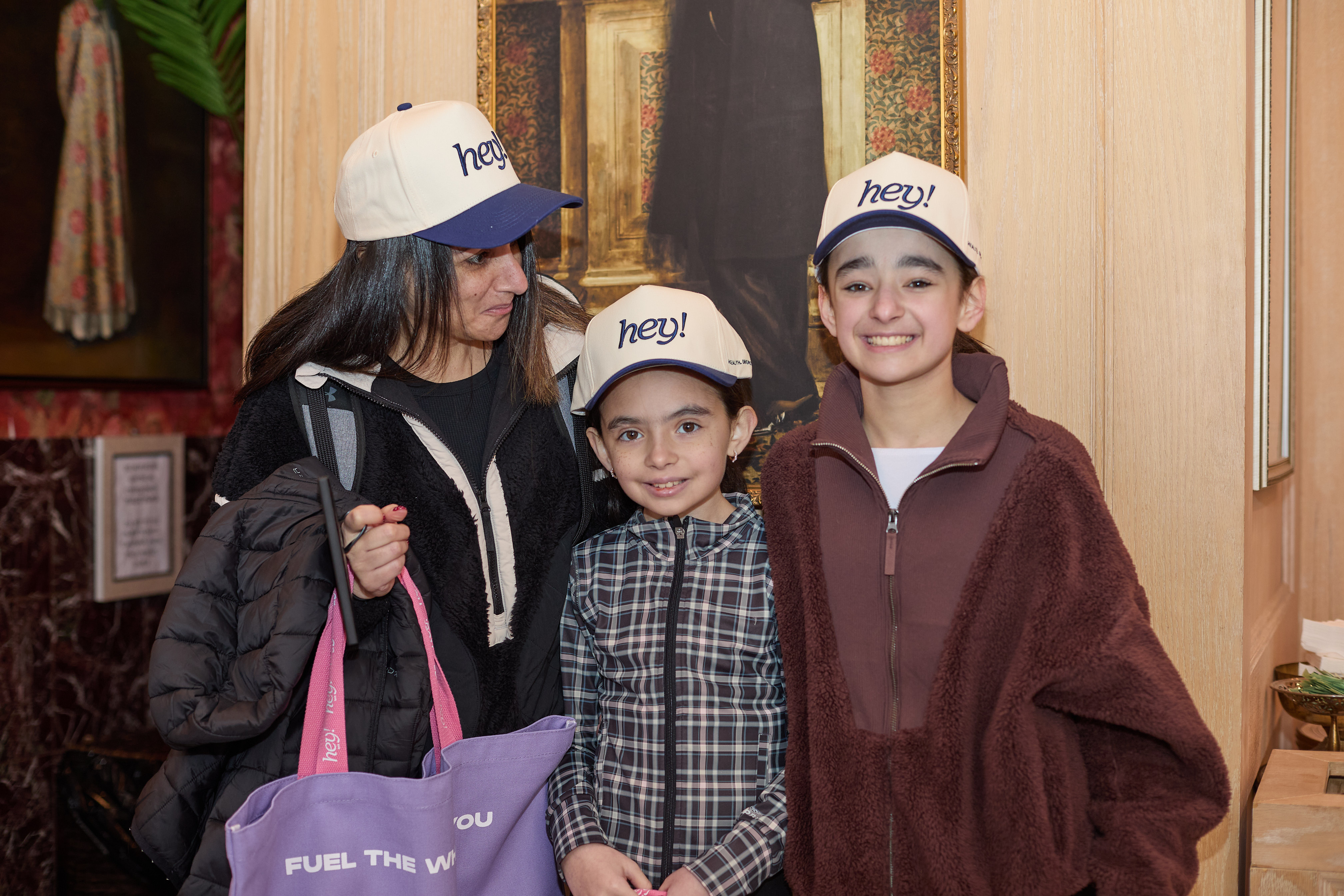 Three people smilng with they blue hey hats on!