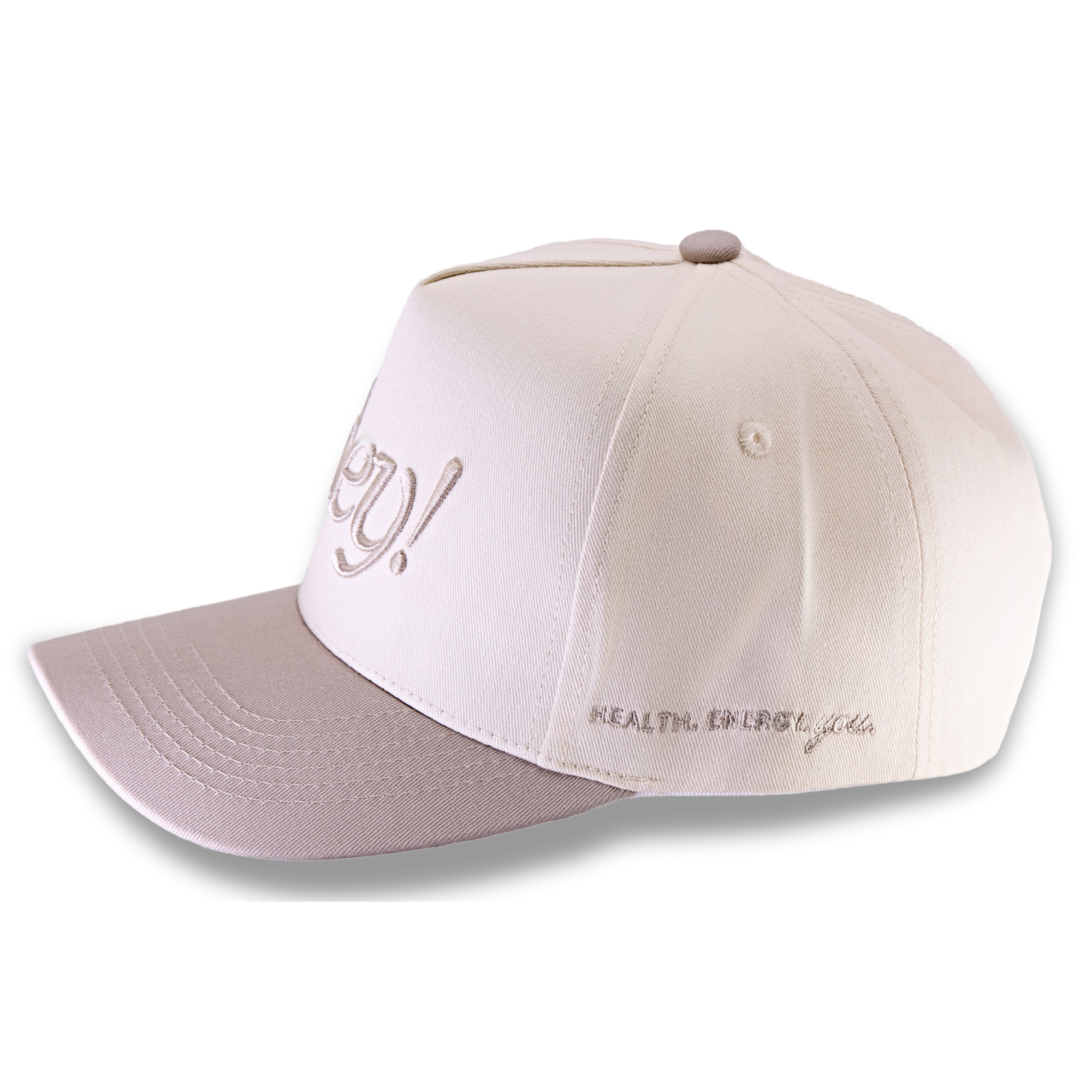 Side view of a cream hat embroidered with “hey!” and the words “health, energy, you."
